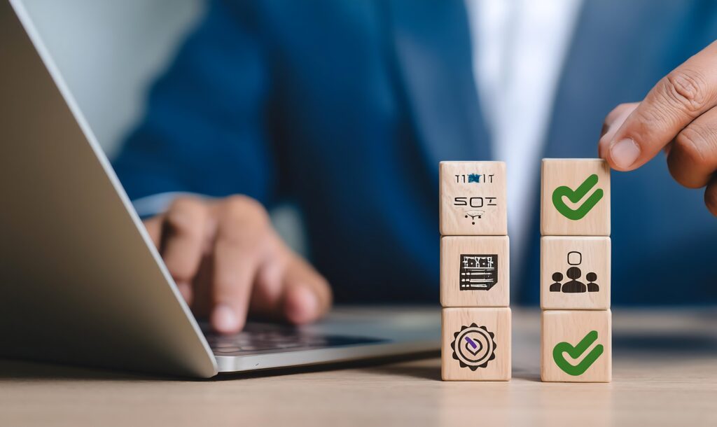 Lawyer stacking blocks with icons near a laptop, symbolizing legal processes and decision-making.